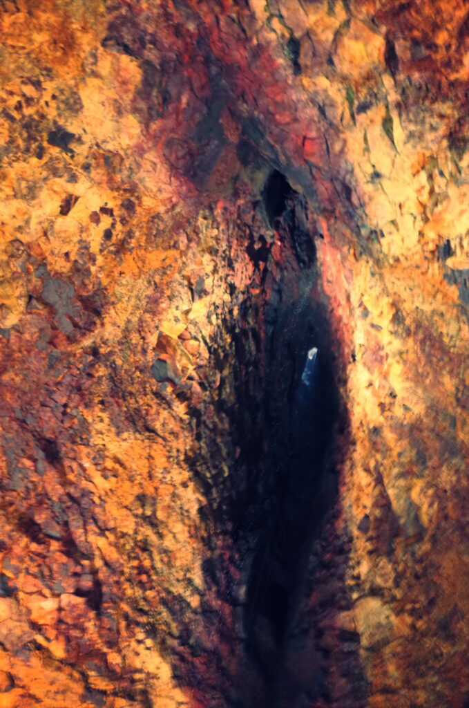 A phtograph picture of the surface of the volcano looking upwards to the entry of the volcano that looks like a females clitorious  