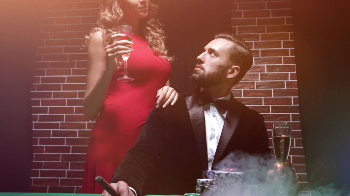 A photgraph of woman in a red dress standing behind a man playing poker to do with a story about Venus retrograde