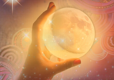 A woman's hand with light orange nail polish holds a round moon underneath a magic firefly photo overlay, sparkle dust. A golden star burst in the top left corner. In the background are multicoloured pink, purple, and green geometric swirly shapes. On the top right is the website name, barefootastrologer.com