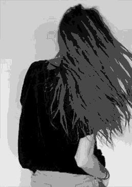 Black and white gif of a girl with long dark hair, in a black t-shirt, seen from behind as she gathers her hair into an updo — representing self-image and the 1st house in astrology.