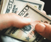Moving image of a hand counting US $50 dollar bills to represent the 2nd house in astrology
