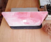 My photograph of my Pink and white covered MacBook Pro on a wooden desk