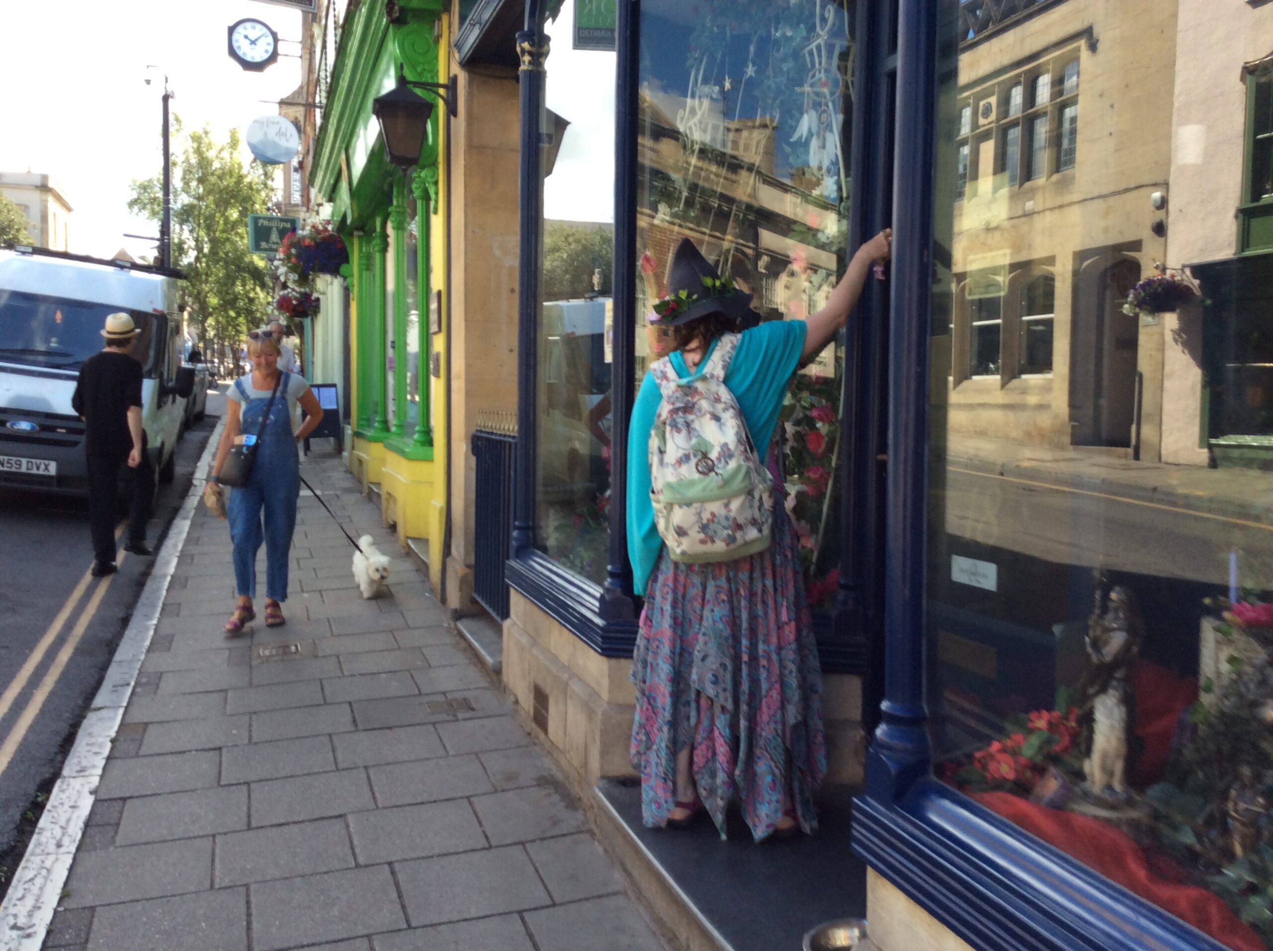 My Phtograph of a woman in Glastonbury appears to be a shop/ store owner closes the shop dressed as in coustume as a pagan moden day witch