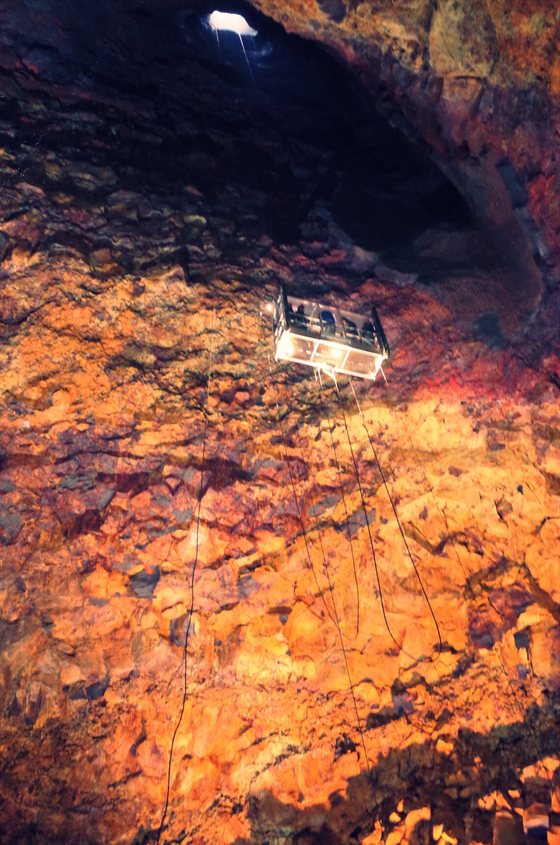 My photograph of a lift inside a volcanco in Iceland with people inside it decending downwards