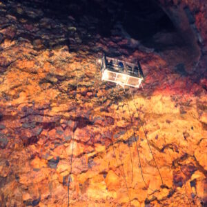My photograph of a lift inside a volcanco in Iceland with people inside it decending downwards