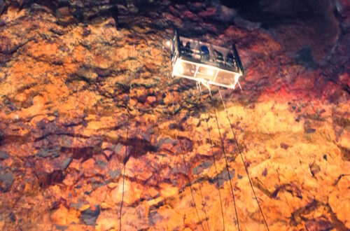 My photograph of a lift inside a volcanco in Iceland with people inside it decending downwards