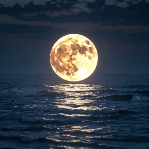 A large glowing full moon rising or suspended over a ocean